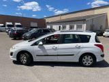 a white car parked in a parking lot next to a building