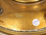 a close up of a gold plate with a sticker on it