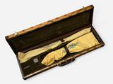a wooden case with a pair of gloves in it