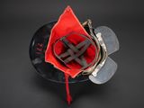 an overhead view of a red and black fire helmet with a red ribbon