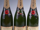 three bottles of champagne sitting next to each other on a table