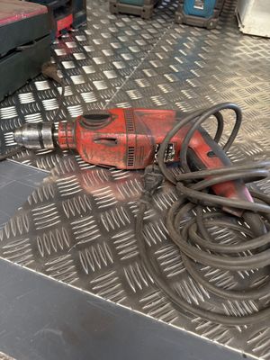 an image of a drill on a metal floor