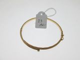 a close up of a wire bracelet with a price tag on it