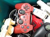 many video game controllers in a green container