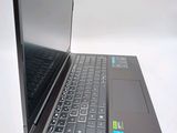 a black laptop with a blue keyboard on a white surface