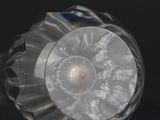 a close up of a glass object on a black surface