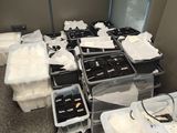 a room with a lot of boxes of clothes on the floor