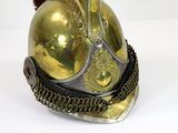 a gold helmet with a red pom pom on it