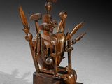 an image of a wooden sculpture of a person with a bird on top of it