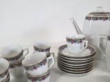 a lot of cups and saucers sitting on a table