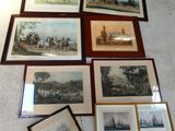 many framed pictures on the floor of a room