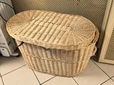 un panier en osier posé par terre à côté d'un radiateur
