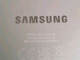the back of a white samsung phone with the samsung logo on it