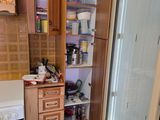 a kitchen with a refrigerator, stove, and cabinets in it