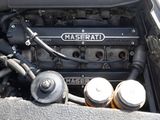 a close up of a car engine with the hood open
