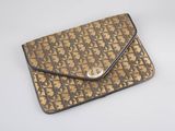 an image of a brown and black purse sitting on top of a white table