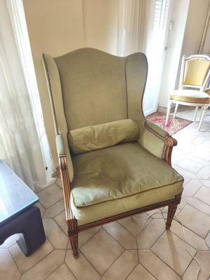 a green chair in the corner of a living room