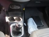 a car dashboard with a gear box and a steering wheel