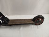 an electric scooter sitting on a white surface with a white background