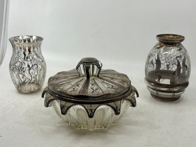 three glass vases sitting on a table next to each other