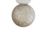 a white bird sitting on top of a white ball