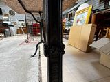 a black table with a metal base in a warehouse