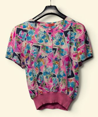 a close up of a shirt on a hanger on a wall