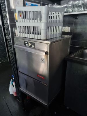 a silver dishwasher sitting next to a sink in a kitchen