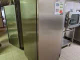 stainless steel refrigerators in a commercial kitchen with tiled floor