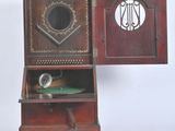a small wooden cabinet with a clock on top of it
