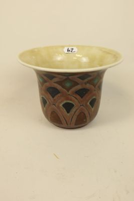 a brown and green bowl on a white table