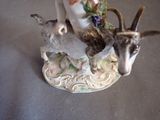 a figurine of a goat and a bird on a table