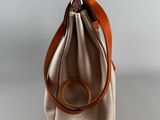 beige and brown canvas bag with leather handle