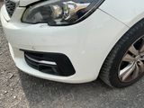 a white car that is parked on the side of the road
