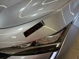a close up of a car ' s headlight with a sticker on it