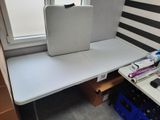 a white table with a laptop on top of it