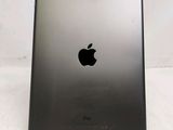 an apple ipad sitting on top of a table next to a white wall
