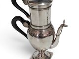 silver plated coffee pot with black handle and black handle
