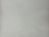 an old photo of a man standing in front of a white wall