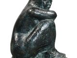 a statue of a man sitting on a rock with his head in his hands