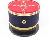 a red and blue hat with a gold emblem on it