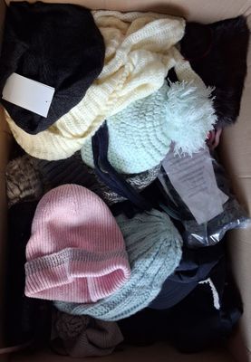 a box full of clothes and hats that are in it