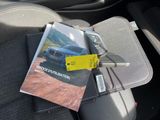 a magazine on the seat of a car with a car key in it