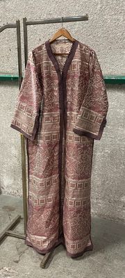 a coat hanging on a clothes rack in a room