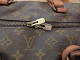 a close up of a brown louis vuitton bag
