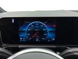 a car dashboard with a digital speedometer and a steering wheel