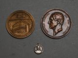 two coins are shown next to each other on a gray surface