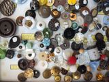 many different types of buttons and buttons on a table
