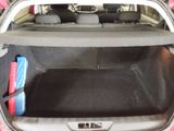 a trunk of a car filled with luggage in a garage