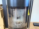 the coffee maker is sitting on the table in front of the box